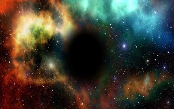Agujero negro en el espacio en un fondo de varios colores con estrellas iluminadas